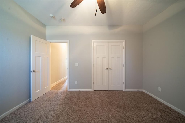 unfurnished bedroom featuring carpet floors, a closet, and ceiling fan