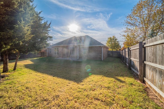 back of property featuring a patio and a lawn