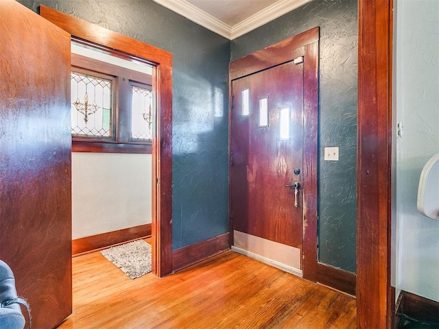 foyer with hardwood / wood-style flooring and ornamental molding