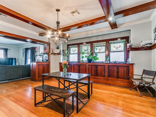 dining room featuring beamed ceiling, light hardwood / wood-style flooring, crown molding, and a notable chandelier