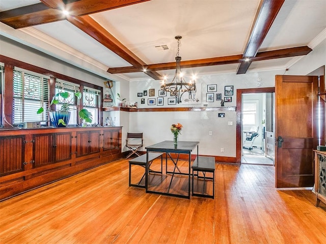 dining area with beam ceiling, light hardwood / wood-style flooring, a healthy amount of sunlight, and coffered ceiling