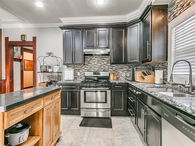 kitchen with dark stone counters, sink, ornamental molding, and appliances with stainless steel finishes