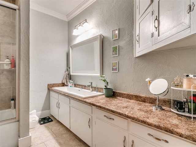 bathroom with tile patterned floors, crown molding, vanity, and enclosed tub / shower combo