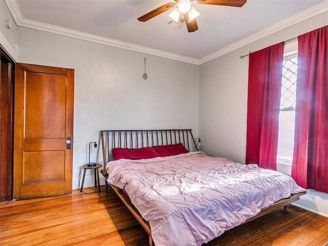 bedroom with ceiling fan, light hardwood / wood-style floors, and crown molding