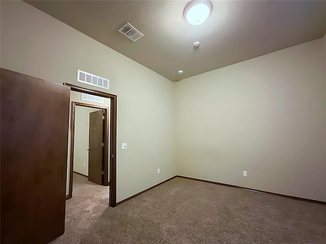 unfurnished room featuring light colored carpet