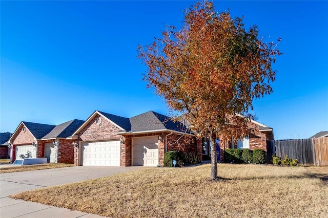 ranch-style house featuring a front yard and a garage