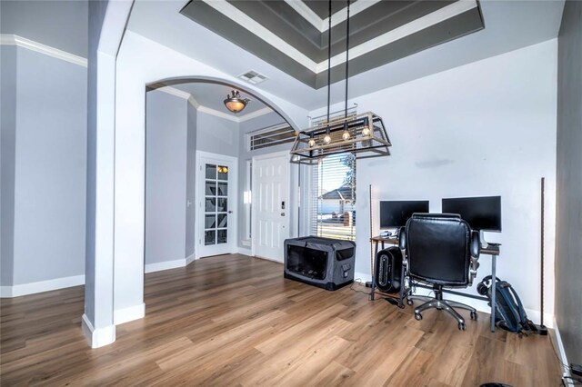 home office featuring hardwood / wood-style floors and ornamental molding