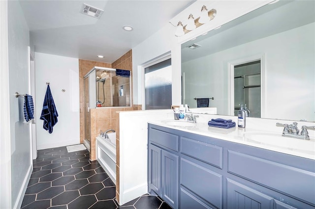 bathroom with tile patterned flooring, vanity, and independent shower and bath