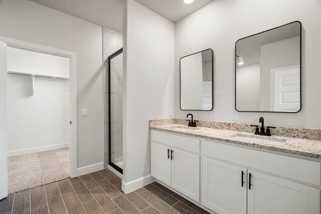 bathroom with vanity and a shower with shower door