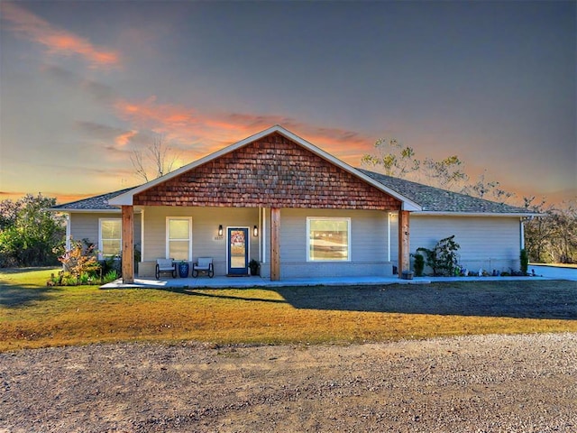 view of front of home with a patio and a yard