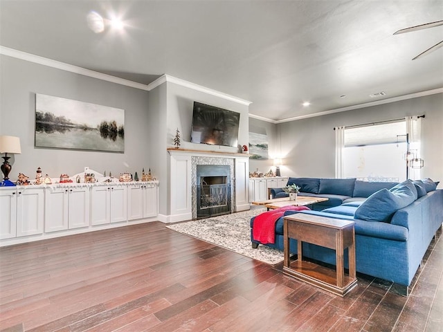 living area featuring visible vents, dark wood-style flooring, a high end fireplace, and crown molding