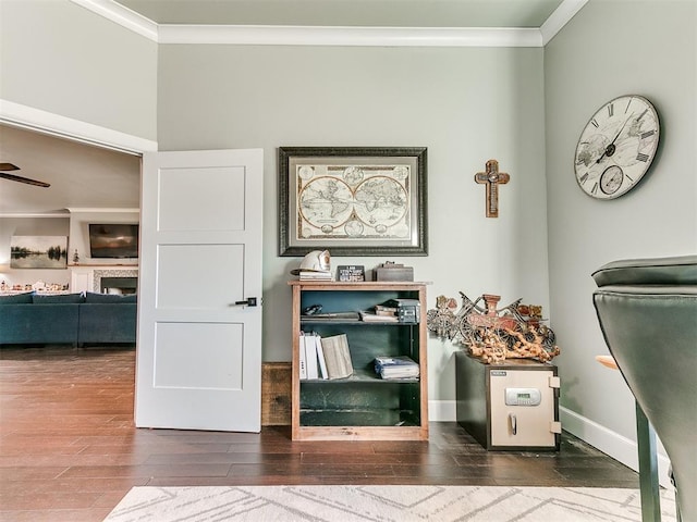 office space featuring ornamental molding, baseboards, and wood finished floors