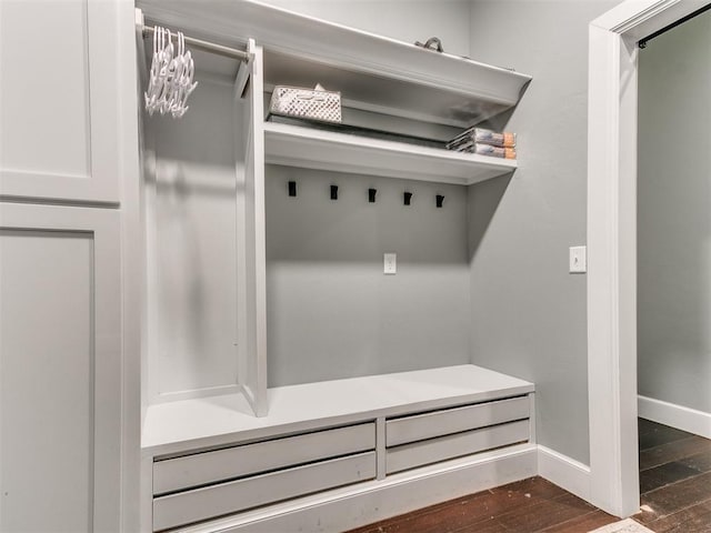 mudroom with baseboards and dark wood-type flooring