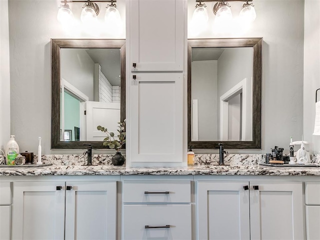 bathroom with double vanity and a sink