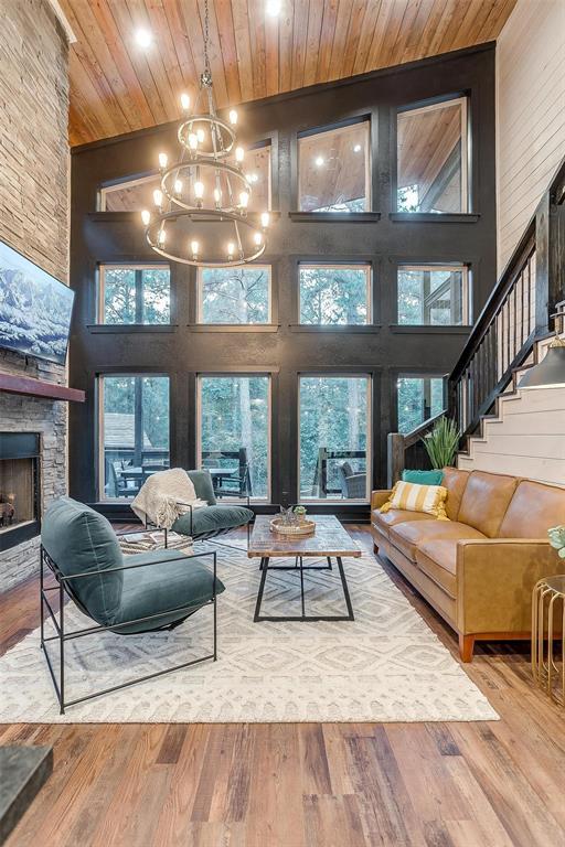 living room with hardwood / wood-style flooring, high vaulted ceiling, and wood ceiling