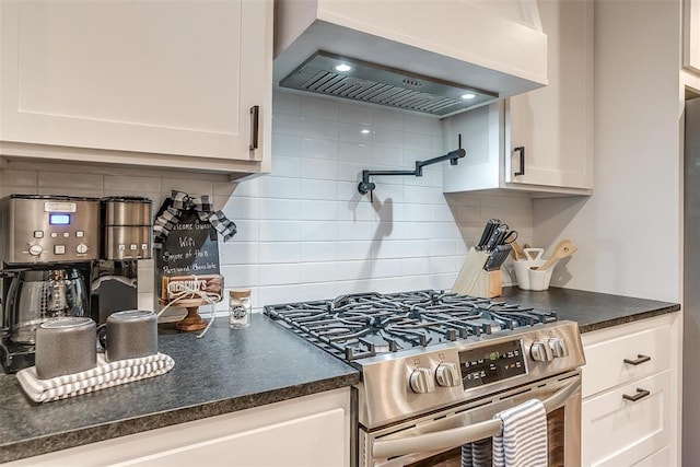 kitchen featuring white cabinets, wall chimney exhaust hood, decorative backsplash, and high end stove