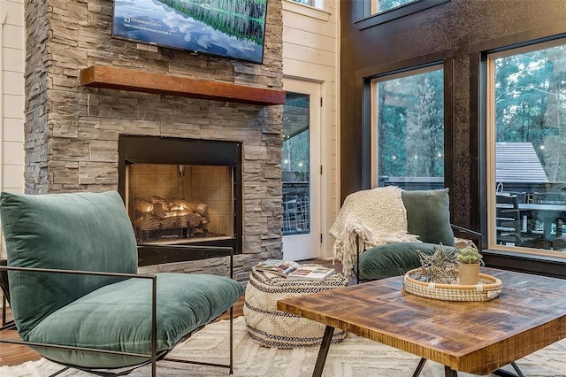 sitting room with hardwood / wood-style flooring and a fireplace