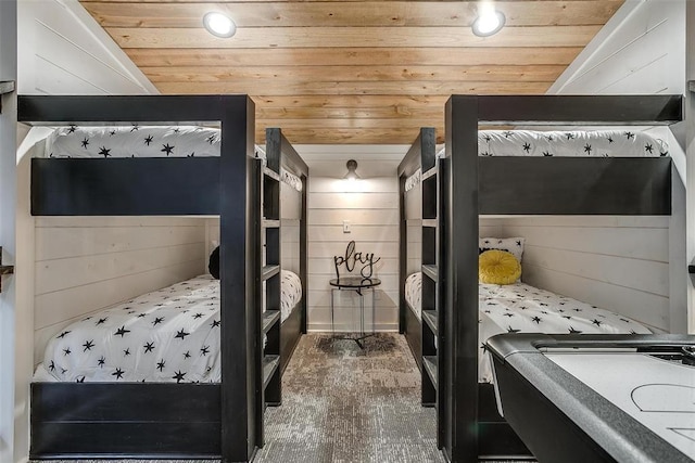 bedroom with wood walls, dark hardwood / wood-style flooring, and wood ceiling