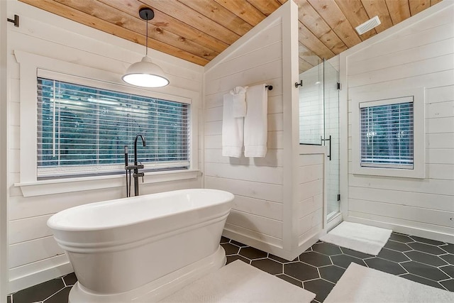 bathroom featuring vaulted ceiling, wooden ceiling, and wood walls