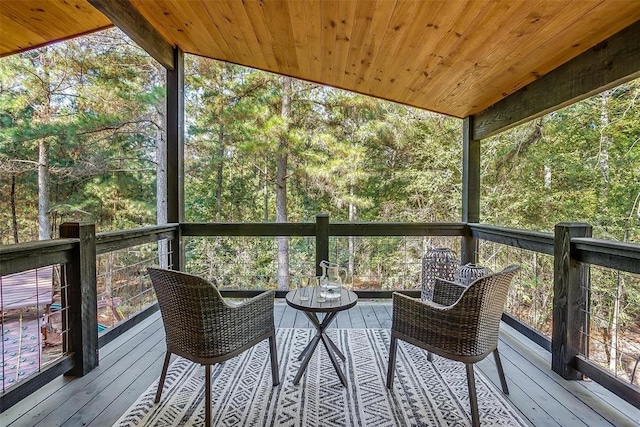 unfurnished sunroom with wooden ceiling and vaulted ceiling