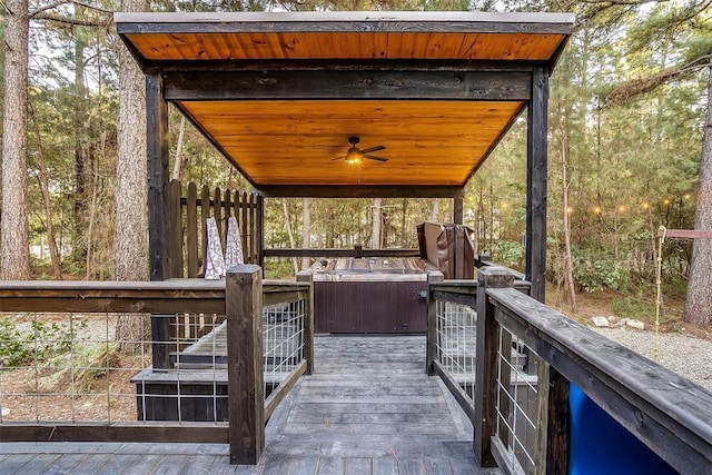 wooden terrace with a jacuzzi and ceiling fan