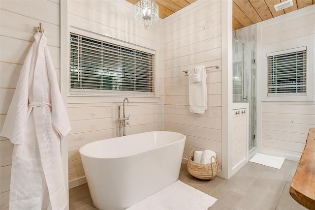 bathroom featuring independent shower and bath, wood walls, and wooden ceiling