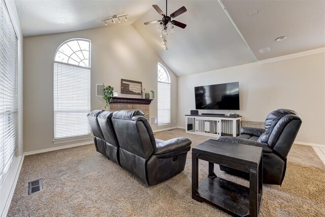 carpeted living room featuring ceiling fan, rail lighting, and high vaulted ceiling