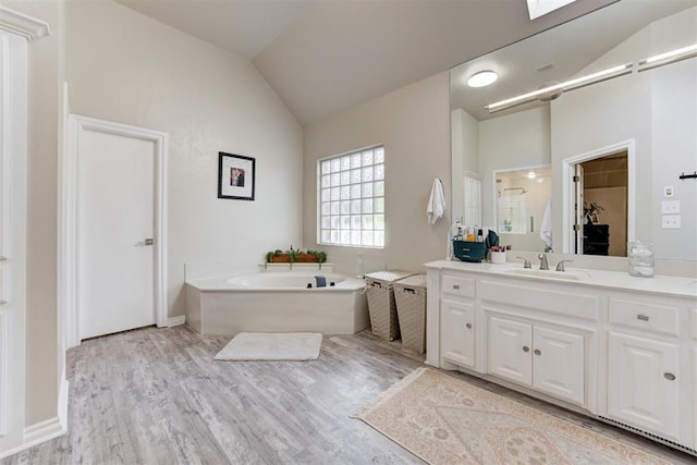 bathroom with vanity, separate shower and tub, wood-type flooring, and lofted ceiling