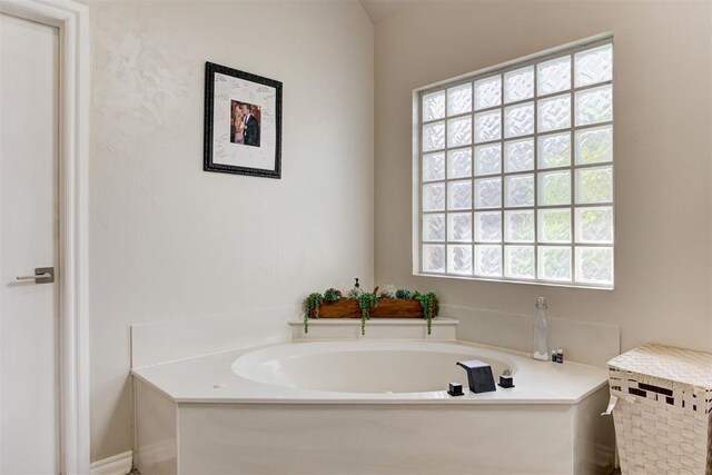 bathroom featuring a tub to relax in