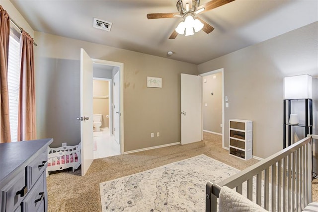 carpeted bedroom with stainless steel fridge and ceiling fan