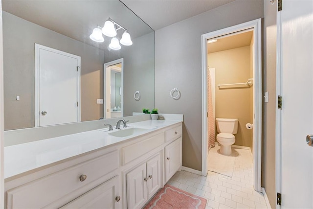 bathroom featuring toilet, vanity, an inviting chandelier, and tile patterned floors