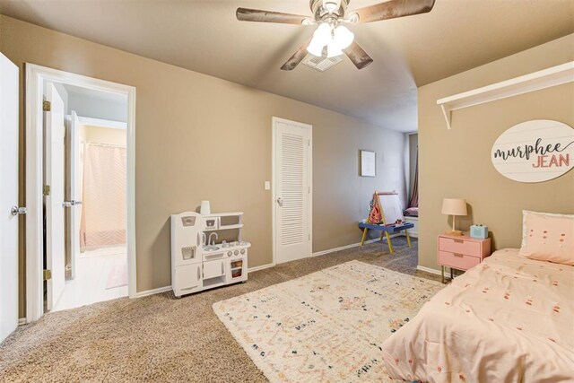 carpeted bedroom featuring ceiling fan and a closet