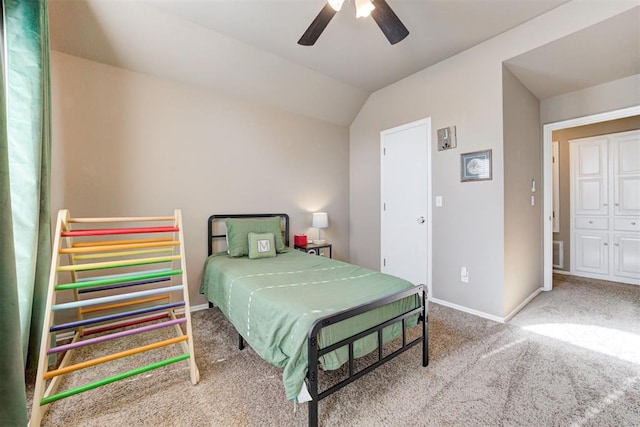 carpeted bedroom featuring a closet, vaulted ceiling, and ceiling fan