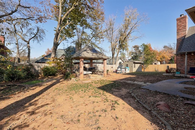 view of yard with a gazebo and a storage shed