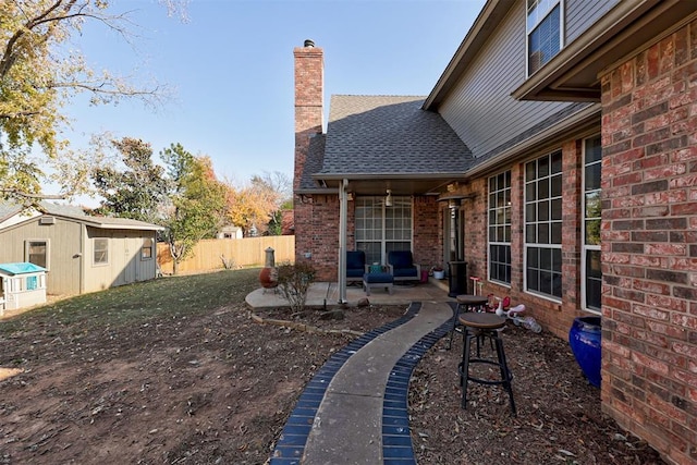 view of yard featuring a patio area and a shed