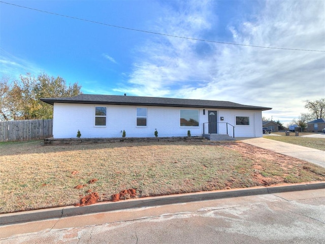 ranch-style home with a front lawn