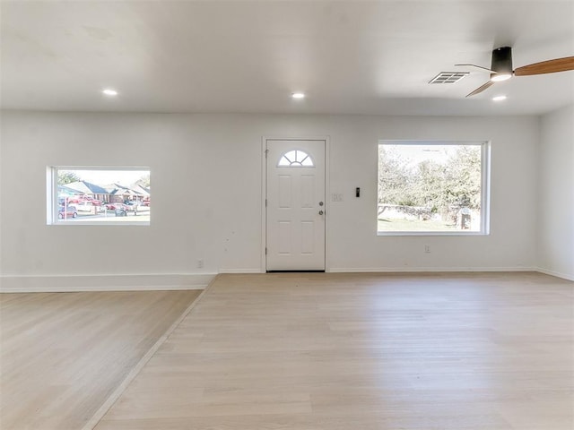 foyer featuring a wealth of natural light, ceiling fan, and light hardwood / wood-style floors