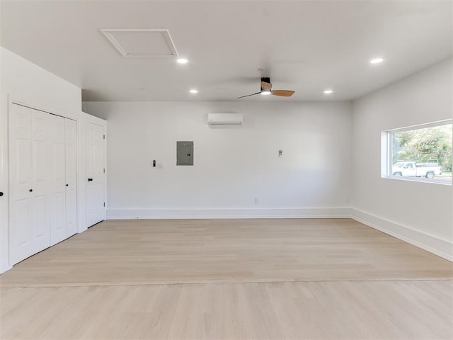 garage with electric panel, ceiling fan, and a wall mounted air conditioner