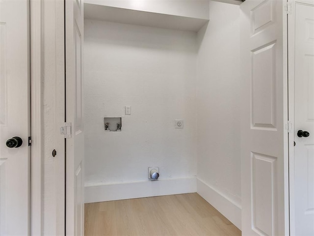 laundry room featuring hookup for an electric dryer, hookup for a washing machine, and light hardwood / wood-style floors