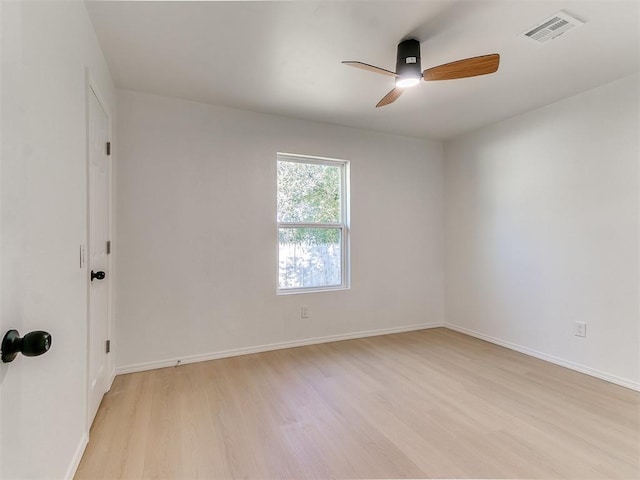 empty room with ceiling fan and light hardwood / wood-style floors