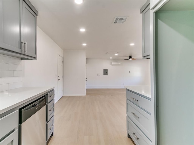 kitchen featuring gray cabinetry, dishwasher, ceiling fan, tasteful backsplash, and light hardwood / wood-style floors