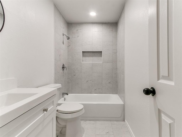 full bathroom with tiled shower / bath, vanity, and toilet