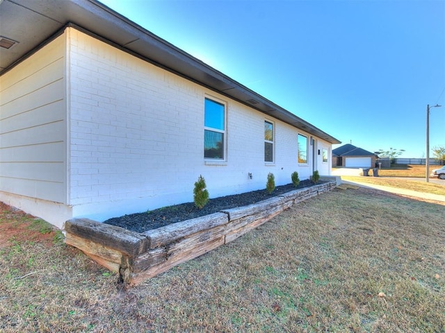 view of side of home featuring a yard