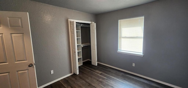 unfurnished bedroom with dark wood-type flooring