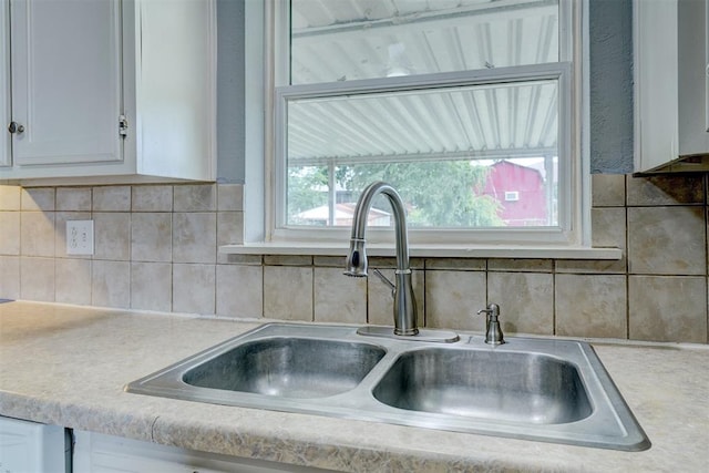 details featuring white cabinets and sink