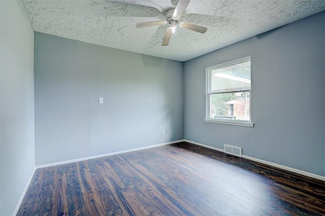 unfurnished room with ceiling fan, dark hardwood / wood-style flooring, and a textured ceiling