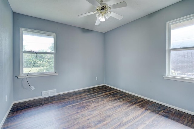 unfurnished room with ceiling fan and dark hardwood / wood-style flooring