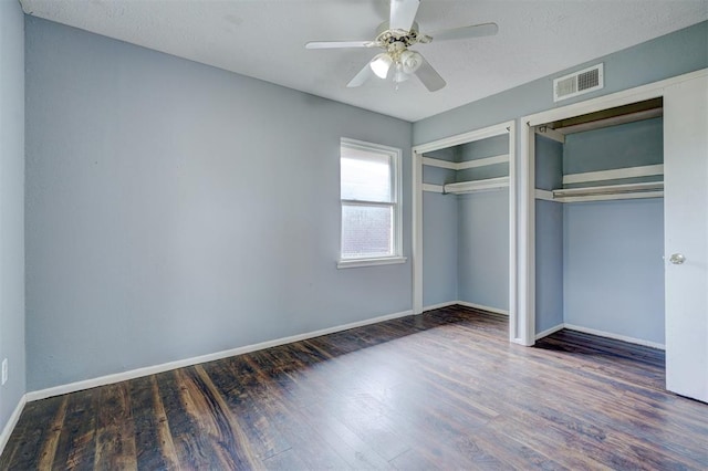 unfurnished bedroom featuring ceiling fan and dark hardwood / wood-style floors