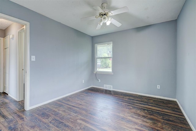 unfurnished room featuring ceiling fan and dark wood-type flooring