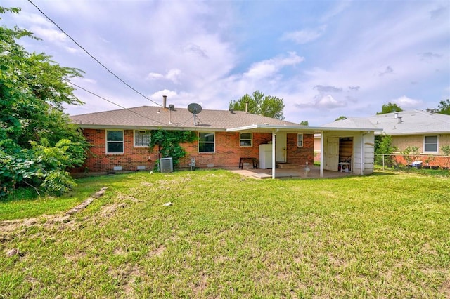 back of house with a patio area, a yard, and central AC